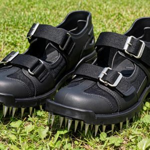 Ohuhu aerator shoes with metal buckle straps and heel support worn on a lawn