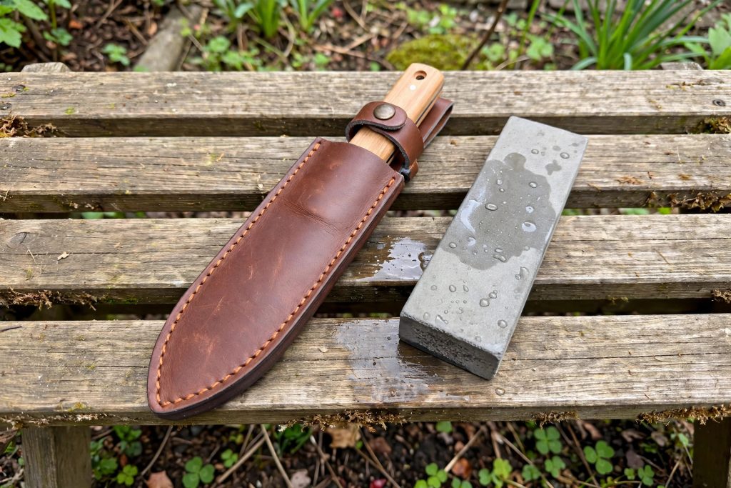 best hori hori knife in a leather sheath with a sharpening stone