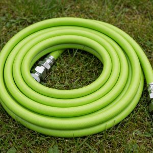 flexzilla swivelgrip garden hose with rotating fittings coiled on a lawn